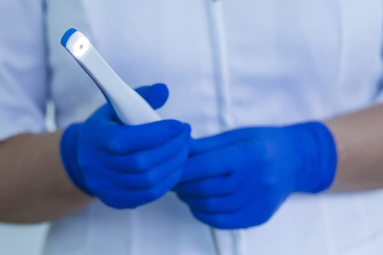 Doctor holding an intraoral camera.