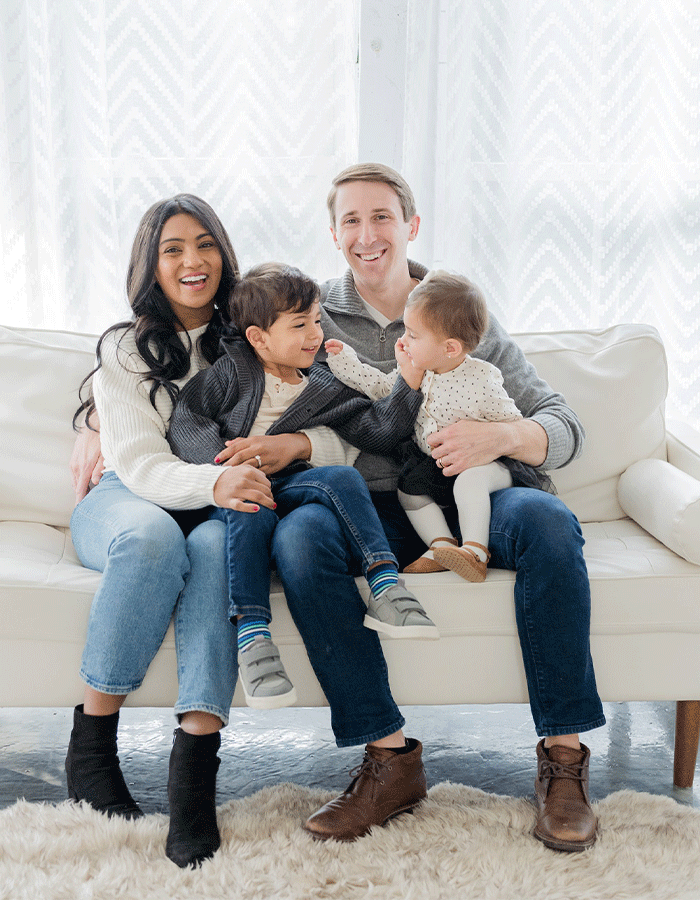 Dr. Nisha and Dr. Max Grosel with their children in a family photo.