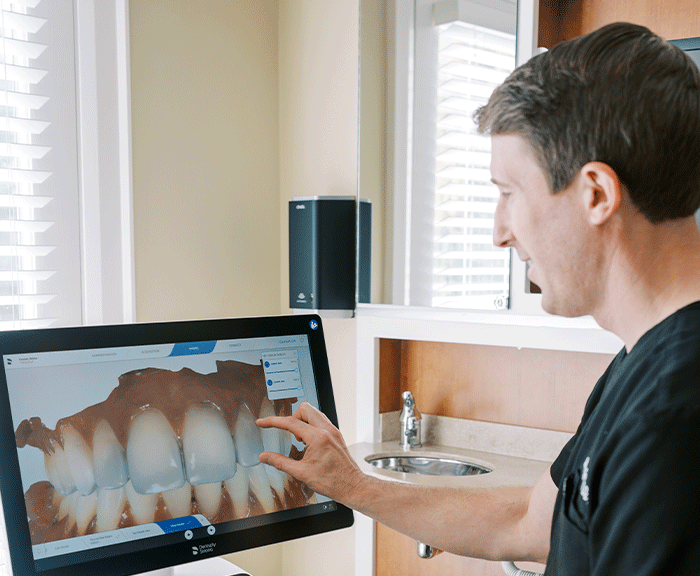 Dr. Max Grosel discussing CEREC® dental scans with a patient.