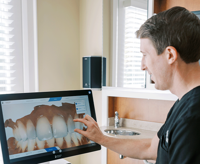 Dr. Max Grosel discussing CEREC® dental scans with a patient.