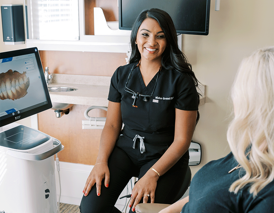 Dr. Nisha Grosel discussing CEREC® dental scans with a patient.