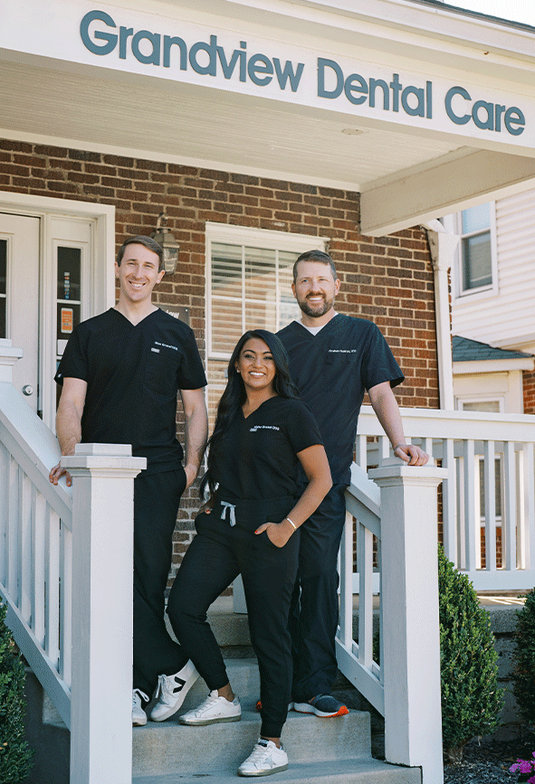Drs. Max Grosel, Nisha Grsel, and Abraham Hoellrich standing in front of Grandview Dental Care in Columbus, OH.